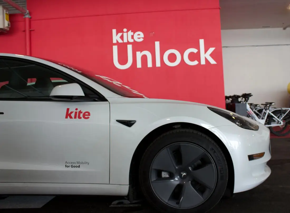 A Kite car parked at the The Taylor hub by the Kite Unlock wall